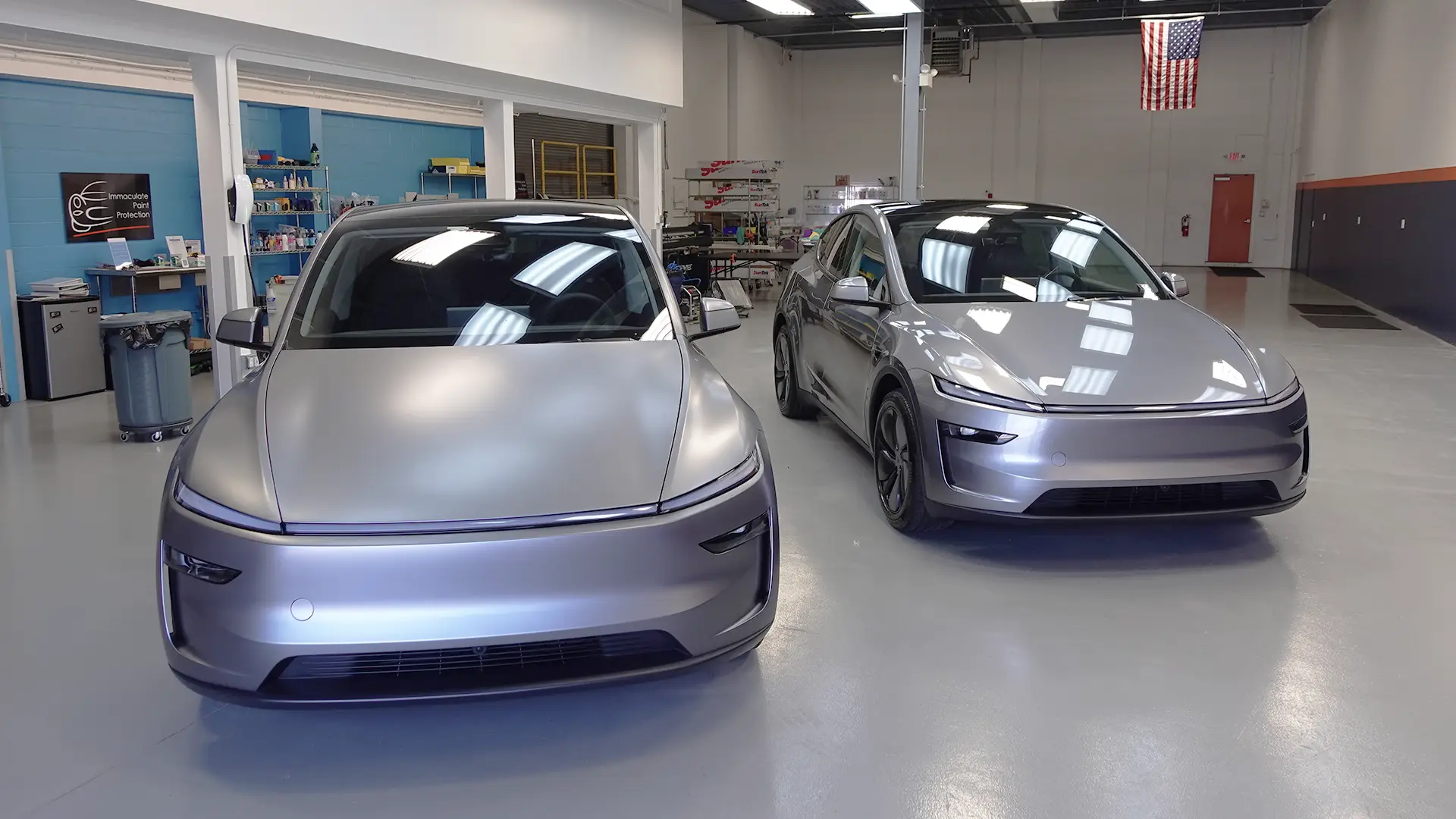 A side-by-side comparison of two Quicksilver 2026 Tesla Model Ys, one showcasing a satin finish with SunTek Matte PPF and the other a deep, high-gloss shine from a Gyeon ceramic coating.