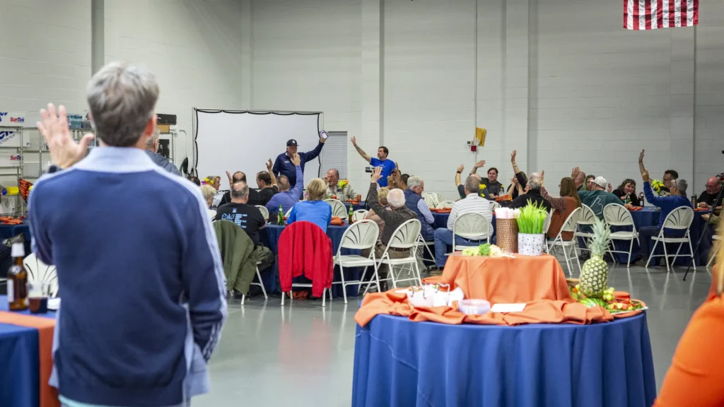 Over 70 members of the Riesentöter Porsche Club sitting for a formal meeting inside the Immaculate Paint Protection shop in Allentown, PA, on March 16, 2022.